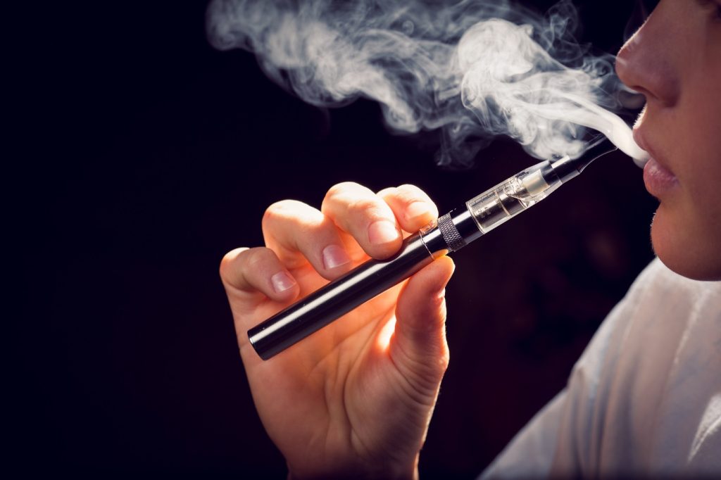 inhaling from an electronic cigarette.